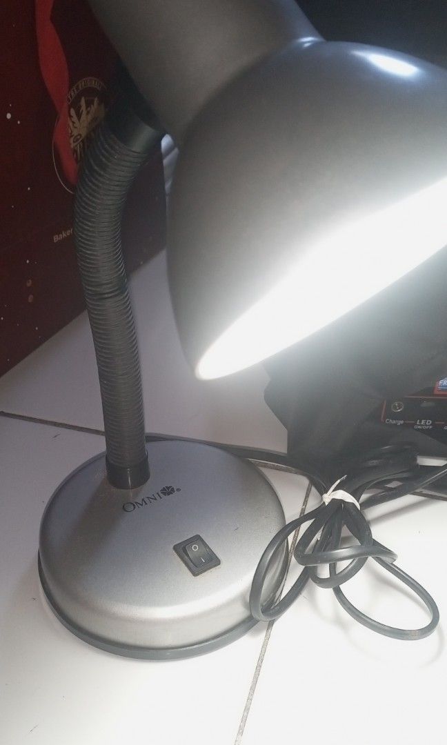 Omni Flexible Desk Lamp / Study Lamp (Category: Everything Else Others) located in Taguig. Submitted by nightwish17 (Listing ID 1468361760, Image 1). Description: Mga Detalye: • Brand: Trusted Omni Brand (Subok na matibay sa electrical appliances) • Flexible Neck: Madaling i-adjust o i-pwesto ang anggulo ng ilaw depende sa kailangan mo. • Heavy Base: May switch sa unahan, matatag sa ibabaw ng lamesa at hindi madaling matumba. • Power: Gagamitin l