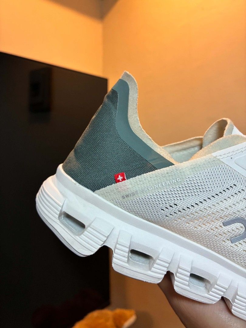 On Cloud Running Shoes White (Category: Sneakers) located in Manila. Submitted by silentbear-c433 (Listing ID 1468394118, Image 2). Description: - Brand: On Cloud - Colorway: White with stylish dark green heel panels - Technology: Signature cloud cushioning for all-day comfort - Fit & Feel: Super lightweight and breathable mesh upper - Features: Hassle-free speed lacing system - Condition: Clean white rubber outsoles, ready for daily wear.