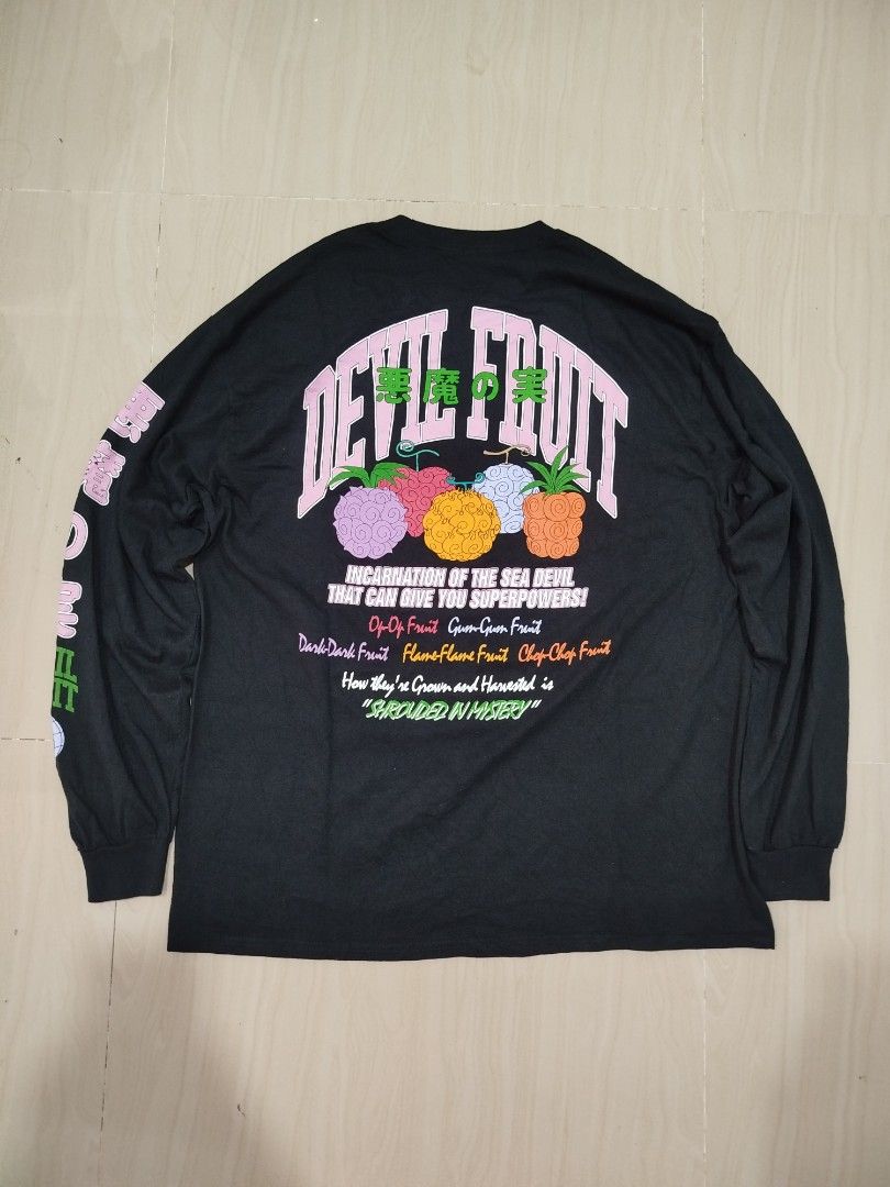 One Piece Devil Fruit Long Sleeve (Category: Coats, Jackets and Outerwear) located in Aroroy. Submitted by dr0p-a-dr1p (Listing ID 1468331053, Image 2). Description: Width: 23 Length: 28 - Official One Piece anime merchandise by Ripple Junction & BoxLunch - Size: XL - Color: Black - Material: 100% cotton (Made in Nicaragua) - Features: Devil fruit graphics on chest, sleeve, and back - Condition: Excellent, no major flaws or wear on fabric.