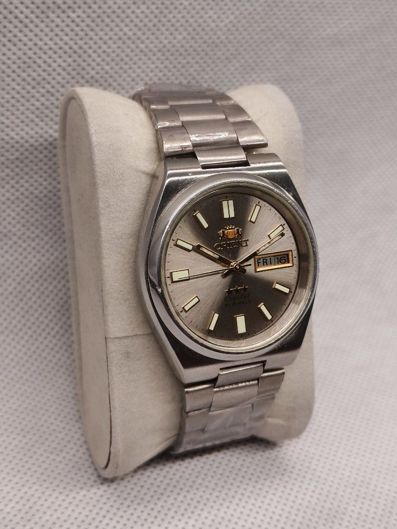Orient "3 Star" Crystal Automatic SEM1T018K8 (Category: Men's Watches) located in Pasig City. Submitted by timepiece-and-co (Listing ID 1468400661, Image 2). Description: Key Characteristics: Brand: Orient (Made in Japan) Line: Tri-Star / 3 Star Crystal Movement: 21 Jewels Automatic (self-winding mechanical movement) Features: A day/date calendar window at the 3 o'clock position and an integrated stainless steel bracelet.