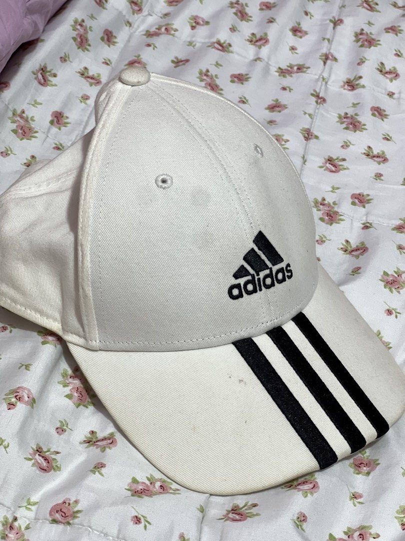 Original Adidas White Cap with Black Stripes (Category: Caps & Hats) located in Pasig City. Submitted by morilove (Listing ID 1468312605, Image 1). Description: - Authentic Adidas classic white baseball cap - Features iconic 3-stripes on the brim and embroidered logo - Adjustable strap for a one-size-fits-most comfortable fit - Built-in mesh lining for enhanced breathability - Clean, versatile design ideal for casual wear and sports - Ships secur