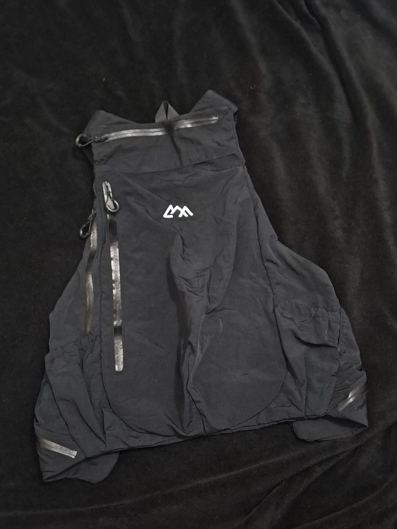 Outdoor Garment Step Out Vest (Category: Backpacks) located in Puerto Princesa. Submitted by jercksthriftph (Listing ID 1468391749, Image 2). Description: Outdoor Garment Step Out Vest - Sleek black technical backpack vest hybrid - Made from durable, water-resistant crinkled nylon - Multiple zipped compartments on front and sides for easy storage - Adjustable straps with heavy-duty buckles for a secure fit - Distinctive white mountain-style logo 