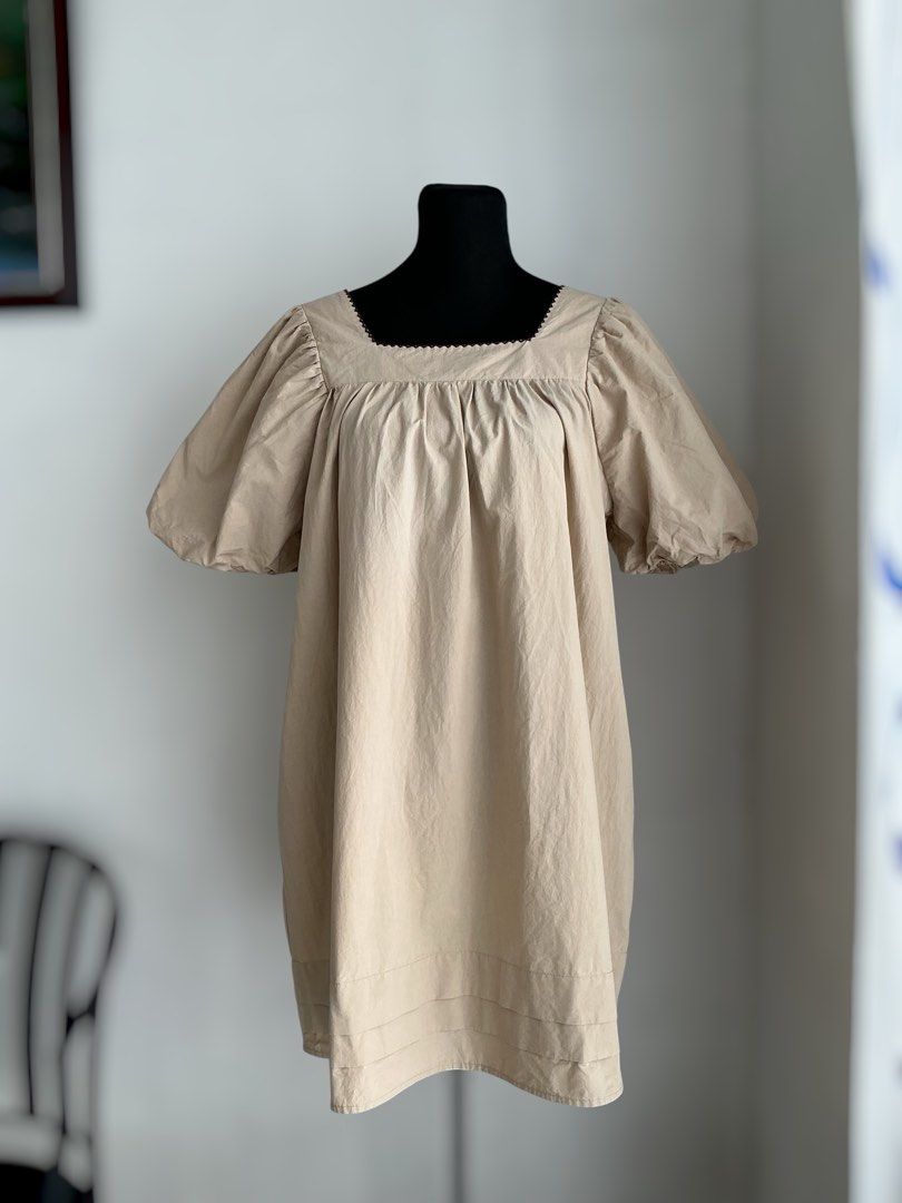 Oversized Puff-Sleeve Mini Dress (Category: Dresses) located in Quezon City. Submitted by engeleaize (Listing ID 1468331676, Image 1). Description: Details: Color: Beige, has washable faint stains on chest area Style: Loose and breezy mini dress, square neckline with embroidered zigzag pattern, voluminous elasticized puff sleeves, horizontal pleats on hemline Fabric: 100% Cotton Best worn: Casual daytime wear, vacation outfits Bust: 44 inches Wai