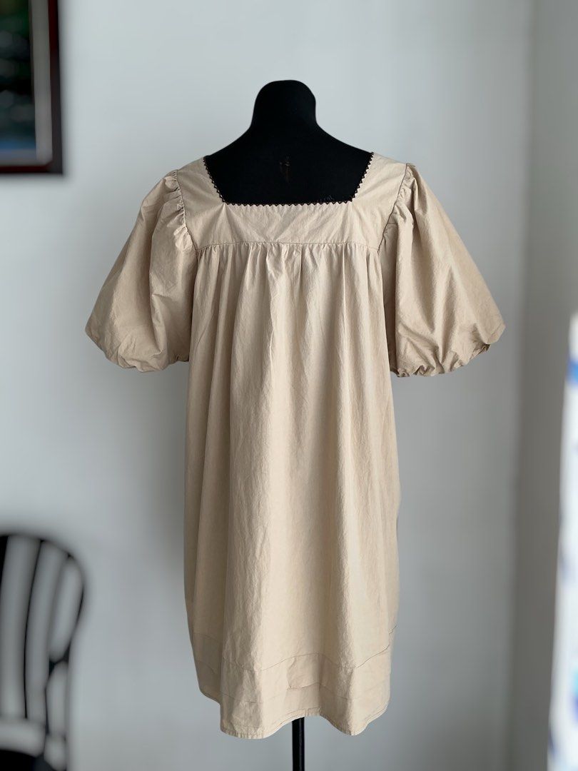 Oversized Puff-Sleeve Mini Dress (Category: Dresses) located in Quezon City. Submitted by engeleaize (Listing ID 1468331676, Image 2). Description: Details: Color: Beige, has washable faint stains on chest area Style: Loose and breezy mini dress, square neckline with embroidered zigzag pattern, voluminous elasticized puff sleeves, horizontal pleats on hemline Fabric: 100% Cotton Best worn: Casual daytime wear, vacation outfits Bust: 44 inches Wai
