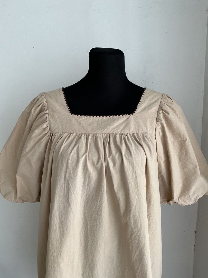 Oversized Puff-Sleeve Mini Dress (Category: Dresses) located in Quezon City. Submitted by engeleaize (Listing ID 1468331676, Image 3). Description: Details: Color: Beige, has washable faint stains on chest area Style: Loose and breezy mini dress, square neckline with embroidered zigzag pattern, voluminous elasticized puff sleeves, horizontal pleats on hemline Fabric: 100% Cotton Best worn: Casual daytime wear, vacation outfits Bust: 44 inches Wai