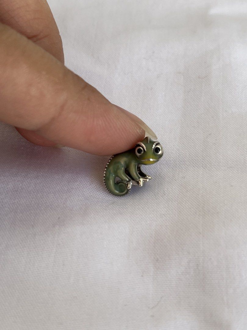 Pandora Green Chameleon Charm (Category: Charms) located in Cebu City. Submitted by jamaica_perez (Listing ID 1468295034, Image 1). Description: - Green chameleon charm with shiny silver hardware - Features intricate back scales, curled tail, and striking black enamel eyes - Compatible with standard charm bracelets - A cute addition to any bracelet stack collection - like new and ready to ship.
