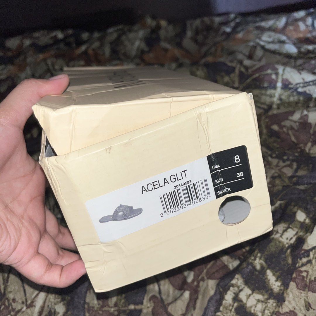 Parisian Acela Glit Silver Sandals Size 38 (Category: Flats & Sandals) located in Pasig City. Submitted by lianjaneryanon (Listing ID 1468378474, Image 3). Description: - Brand: Parisian - Style: Acela Glit Silver Flat Sandals - Size: US 8 / EUR 38 - Features: Sparkly glitter upper straps, metallic footbed, and easy slip-on style - Condition: Brand new with tag attached, comes with original box.