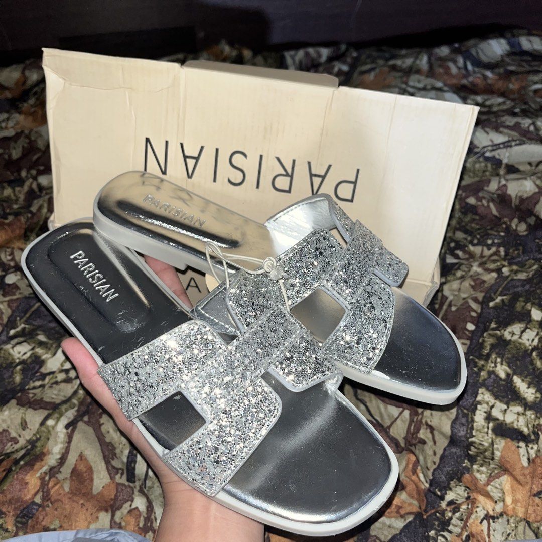Parisian Acela Glit Silver Sandals Size 38 (Category: Flats & Sandals) located in Pasig City. Submitted by lianjaneryanon (Listing ID 1468378474, Image 2). Description: - Brand: Parisian - Style: Acela Glit Silver Flat Sandals - Size: US 8 / EUR 38 - Features: Sparkly glitter upper straps, metallic footbed, and easy slip-on style - Condition: Brand new with tag attached, comes with original box.