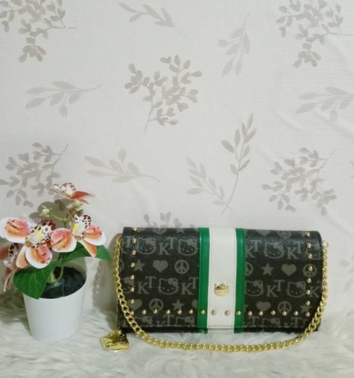 Patterned Crossbody Bag with Gold Chain Strap (Category: Cross-body Bags) located in Manila. Submitted by janetecson05 (Listing ID 1468318438, Image 1). Description: - Dark patterned crossbody bag with eye-catching green and white vertical stripes - Premium gold chain strap and elegant gold hardware details - Chic gold studs along the edges with a secure front flap closure and clasp - Structured rectangular shape that holds its form - Ideal size 