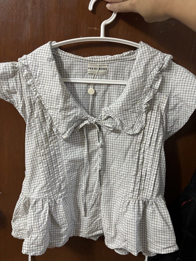 Pee Ka Nong Babydoll (Category: Blouses) located in Manila. Submitted by richoccowhite (Listing ID 1468390337, Image 3). Description: PEE KA NONG BABYDOLL TOP - size s-m - 1st and 2nd photo for inspo only, 3rd and 4th actual photos - functional pearl buttons - with tie front & back rfs: pasabuy bought for 700php, but too tight on my bust area 🥲.