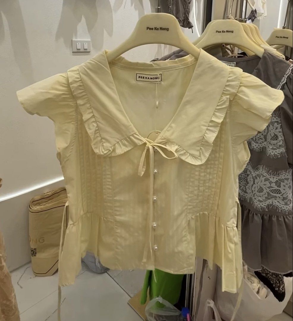 Pee Ka Nong Babydoll (Category: Blouses) located in Manila. Submitted by richoccowhite (Listing ID 1468390337, Image 2). Description: PEE KA NONG BABYDOLL TOP - size s-m - 1st and 2nd photo for inspo only, 3rd and 4th actual photos - functional pearl buttons - with tie front & back rfs: pasabuy bought for 700php, but too tight on my bust area 🥲.
