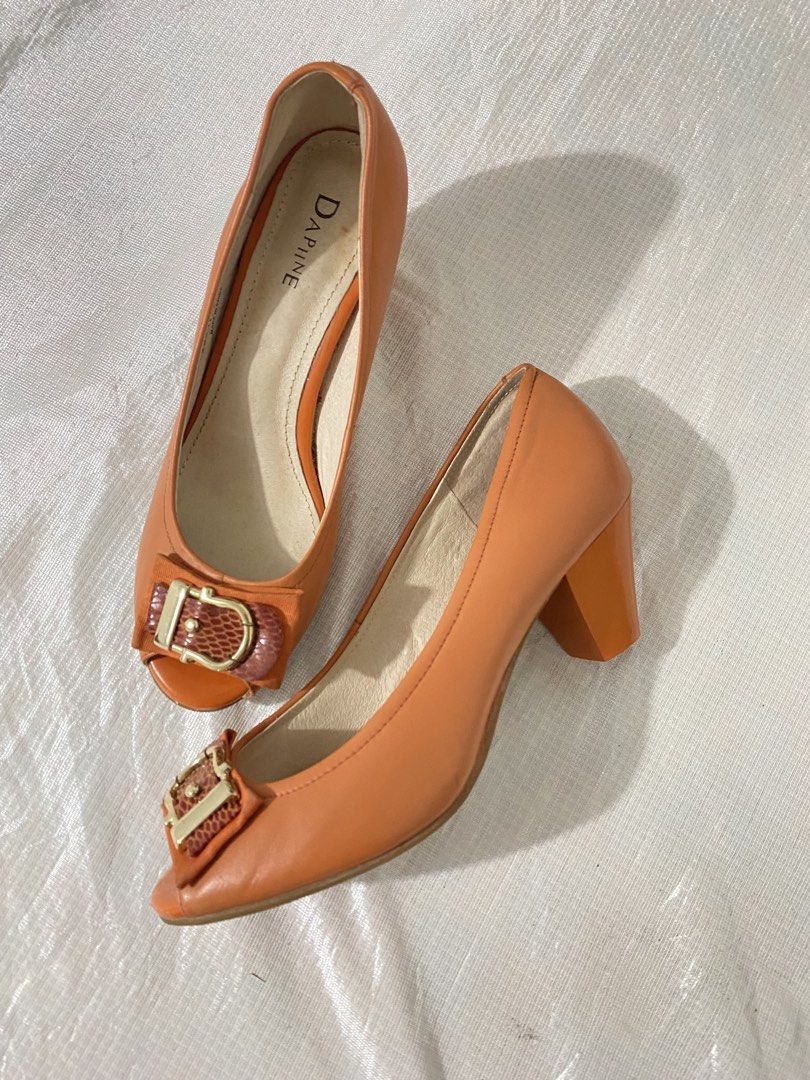 Peep-Toe Block Heel Pumps / Heels (Category: Flats & Sandals) located in Baguio. Submitted by sollunathrift13 (Listing ID 1468447905, Image 1). Description: Color: Warm Terracotta / Burnt Orange Material: Faux Leather / Leatherette Size: 240 (mm) — equivalent to EU 37–38 / US 7 / UK 4.5 (~24 cm foot length) Front Accent: Decorative bow strap with a gold-tone buckle and textured snakeskin-pattern inlay. Heel Style: Sturdy mid-height block heel. Up