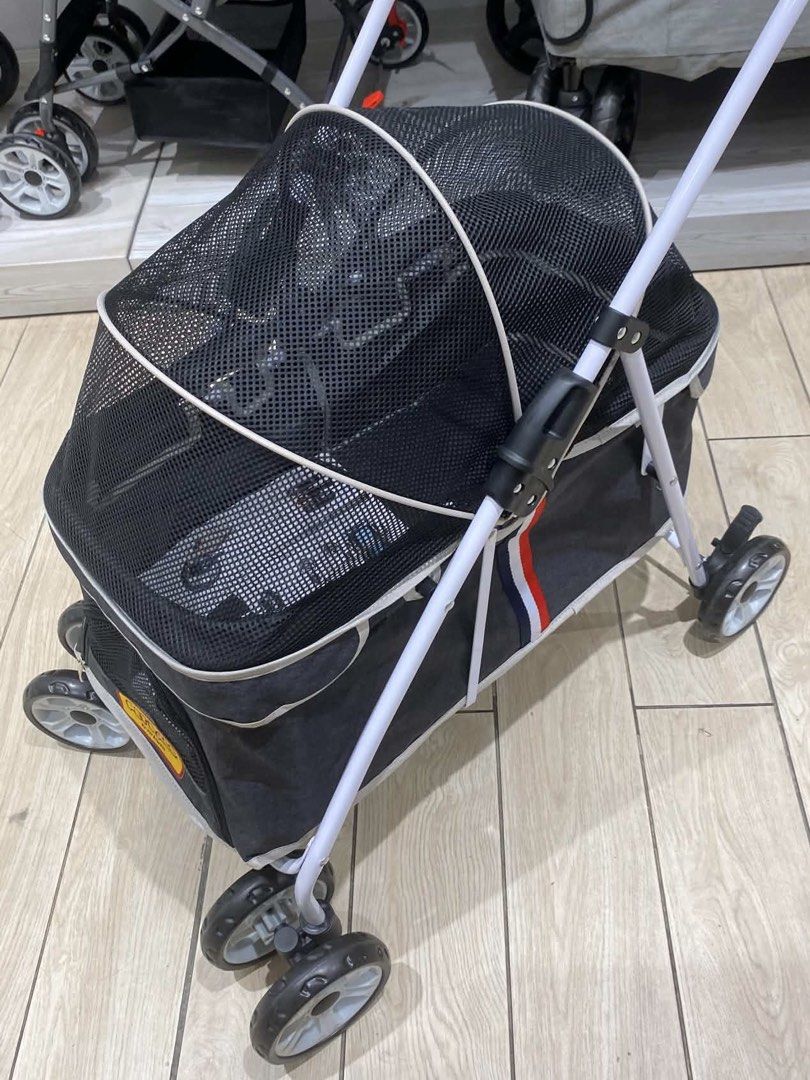 Pet Stroller with Canopy for Dogs & Cats (Category: Homes & Other Pet Accessories) located in Manila. Submitted by jillibeans (Listing ID 1468436554, Image 2). Description: • Brand: Pet Pals by Pet Express • Can fit 2 medium sized dogs (for reference the Shih Tzu in the photo is 5kg) • With a pet flap at the front • With pocket at the back • With canopy • Barely used.