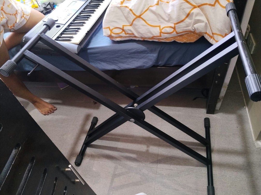 Piano Stand (Category: Musical Instruments) located in Malabon City. Submitted by noblecloud_3509ee (Listing ID 1468335496, Image 2). Description: - Type: Double X-style piano keyboard stand - Color: Black - Condition: Good (7/10 condition) - Features: Adjustable height for comfortable playing - Material: Sturdy metal construction - Fulfillment: Meetups at Holy Child Academy, Kingspoint Subdivision, QC or shipping (buyer pays delivery fee).