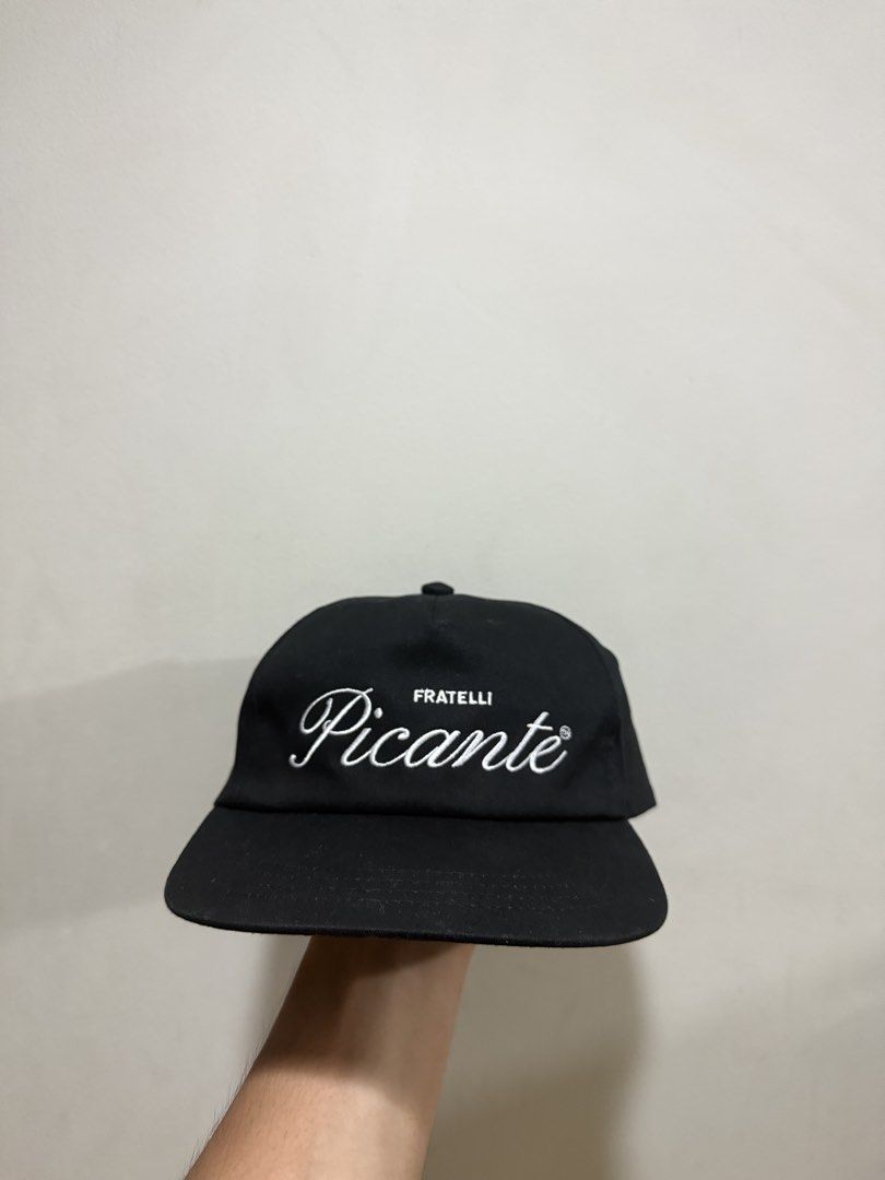Picante Fratelli Black Cap (Category: Caps & Hats) located in Manila. Submitted by ajaycastro25216 (Listing ID 1468423457, Image 1). Description: - Brand: Picante - Color: Black - Design: Fratelli embroidery on front, small 'P' logo on side and back strap - Fit: Adjustable snapback closure - Details: Clean interior tag featuring www.picante.shop and London, UK info - Condition: Solid condition, clean, and ready to wear.