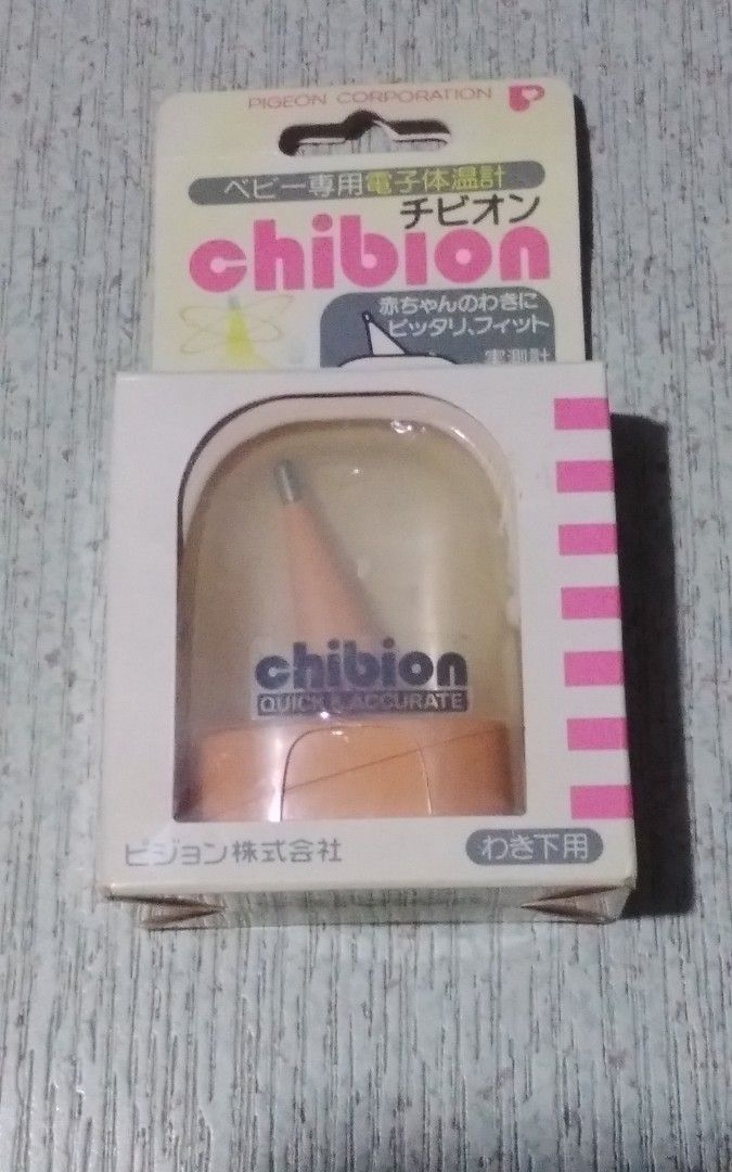 Pigeon chibion baby electronic thermometer (Category: Baby Monitors) located in Quezon City. Submitted by Bernz (Listing ID 1468372141, Image 1). Description: The image shows the retail packaging of a Pigeon Chibion Baby Electronic Thermometer, specifically designed for underarm use . It features a distinct orange and white design and is marked as "QUICK & ACCURATE.".