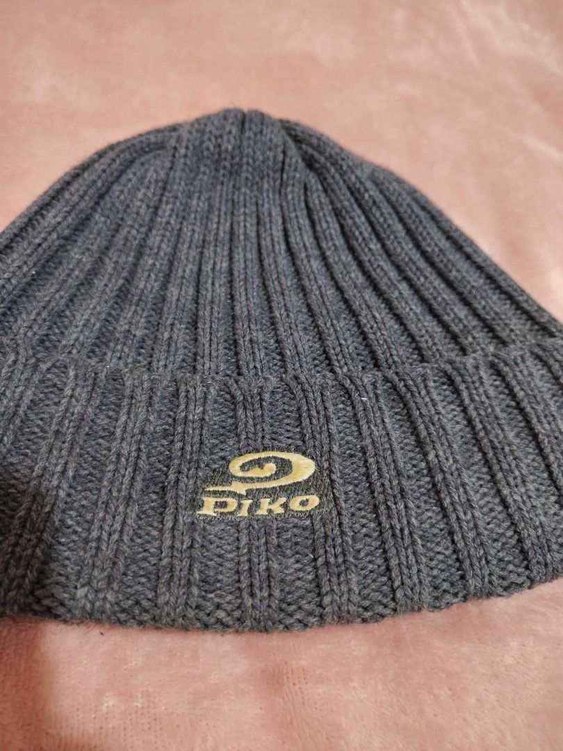 Piko Ribbed Knit Beanie Dark Grey Winter Hat (Category: Hats & Beanies) located in Villasis. Submitted by trip_thrift15 (Listing ID 1468390889, Image 2). Description: - Brand: Piko - Color: Dark grey - Material: Soft ribbed knit texture - Design: Foldover cuff with gold and dark green embroidered logo patch - Condition: Inside tag attached - Features: Keeps your head warm and cozy MOP-GCASH/MAYA JNT COURIER PRICE+SF.