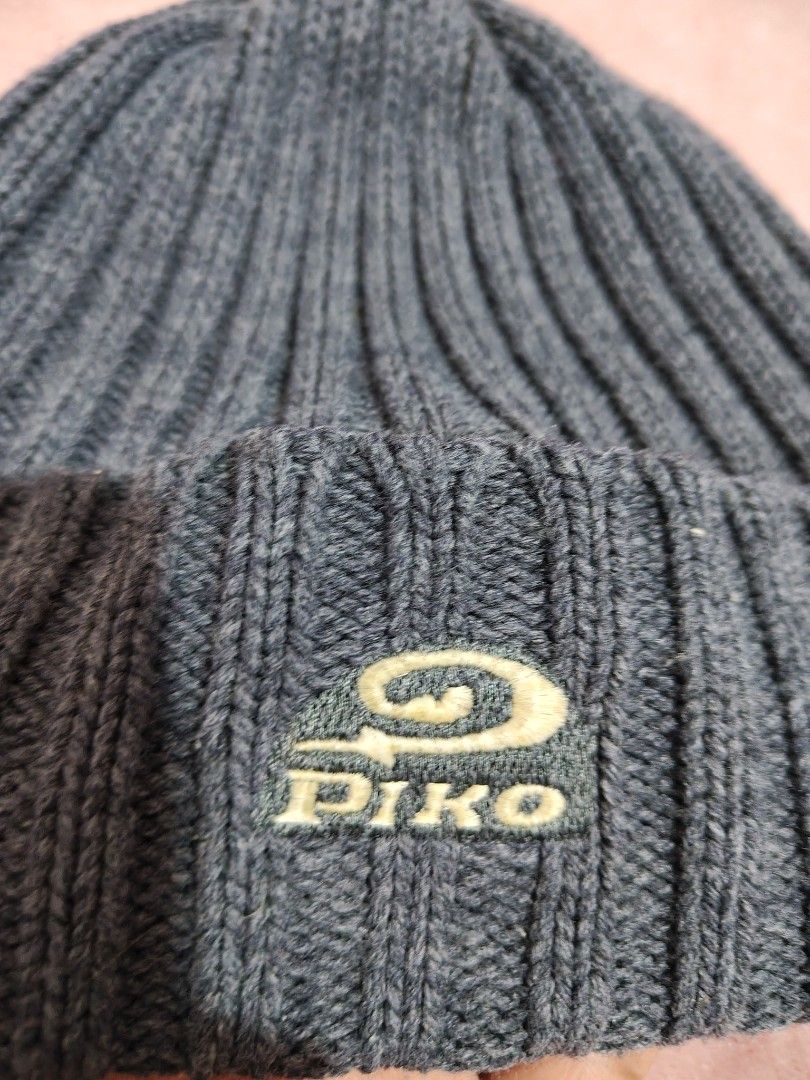 Piko Ribbed Knit Beanie Dark Grey Winter Hat (Category: Hats & Beanies) located in Villasis. Submitted by trip_thrift15 (Listing ID 1468390889, Image 3). Description: - Brand: Piko - Color: Dark grey - Material: Soft ribbed knit texture - Design: Foldover cuff with gold and dark green embroidered logo patch - Condition: Inside tag attached - Features: Keeps your head warm and cozy MOP-GCASH/MAYA JNT COURIER PRICE+SF.