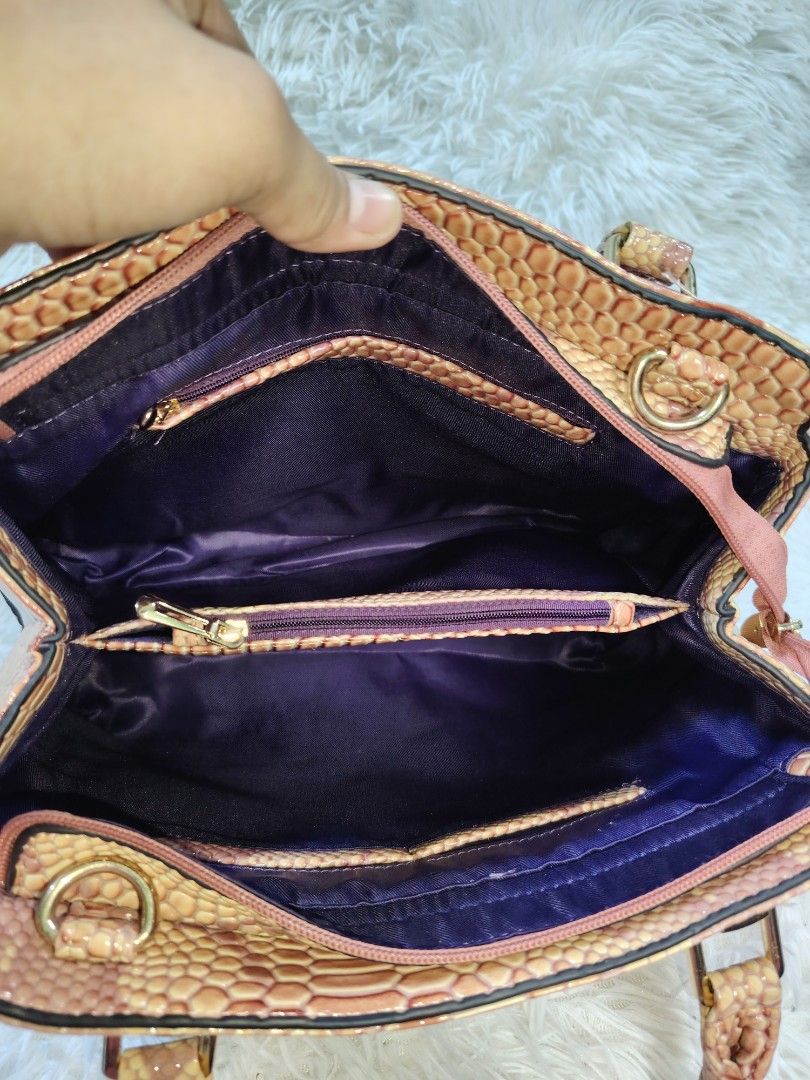 Pink and beige snakeskin pattern handbag with shoulder strap (Category: Cross-body Bags) located in Quezon City. Submitted by zhelcloset01 (Listing ID 1468498399, Image 3). Description: - Trendy pink and beige snakeskin print design - Dual top handles plus a detachable strap with cute 'LOVE' lettering - Elegant gold-tone hardware accents - Spacious dark purple fabric lining with multiple compartments and zippered pockets - Convenient back zipper 