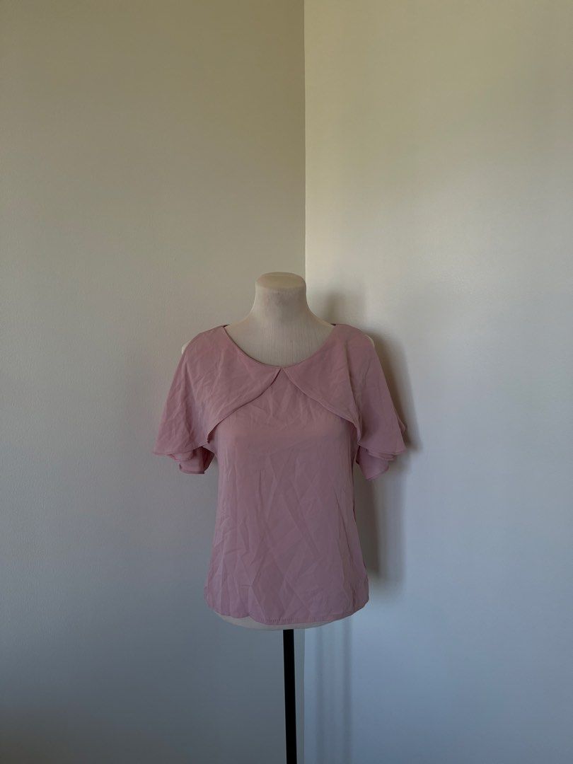 Pink cold shoulder blouse with layered ruffle collar (Category: Blouses) located in Mandaluyong City. Submitted by bravedeer.020ad7 (Listing ID 1468366949, Image 1). Description: - Color: Dusty pink - Style: Short sleeve with trendy cold shoulder cutouts and layered mock collar - Fit & Fabric: Lightweight material that drapes nicely, measures ~20 inches from shoulder to hem - Versatility: Easy to dress up with trousers or keep casual with jeans -