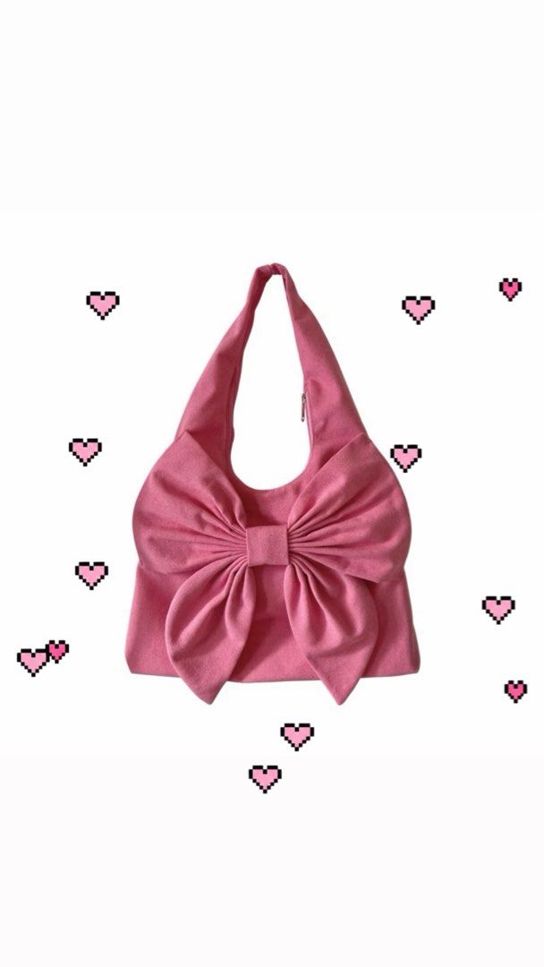 Pink Coquette Bow Shoulder Bag (Category: Shoulder Bags) located in Las Pinas. Submitted by hachimichimichiii (Listing ID 1468466837, Image 1). Description: This is a BRAND NEW PINK CANVAS RIBBON BAG featuring an oversized bow design on the front. It is spacious enough to fit a 13” laptop, making it both stylish and functional. The bag includes a D-ring for attaching keychains or small accessories, a secure zipper closure, an additional zipper co