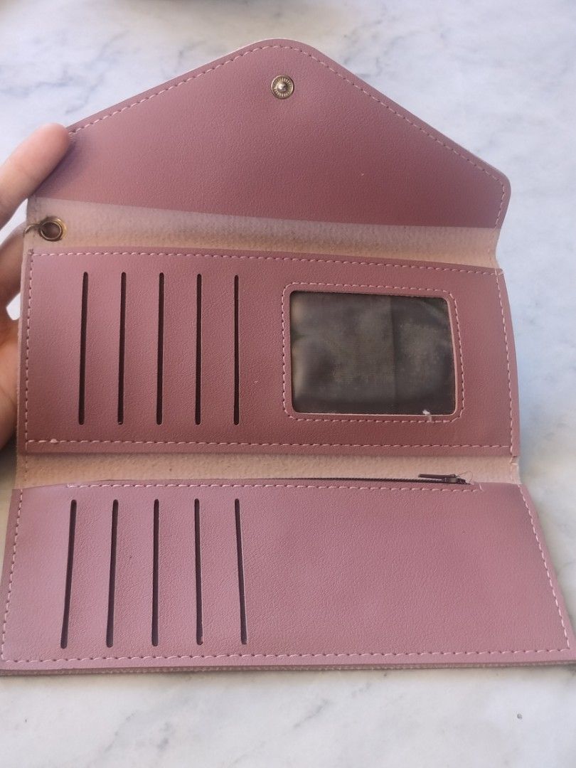 Pink Envelope Long Wallet with Heart Charm (Category: Wallets & Card holders) located in Las Pinas. Submitted by cozychic19 (Listing ID 1468434649, Image 3). Description: Dusty pink faux leather long wallet featuring an envelope flap with snap closure and a cute gold heart charm. Inside includes multiple card slots, an ID window, and a zippered pocket with clean lining. Stylish and functional!.