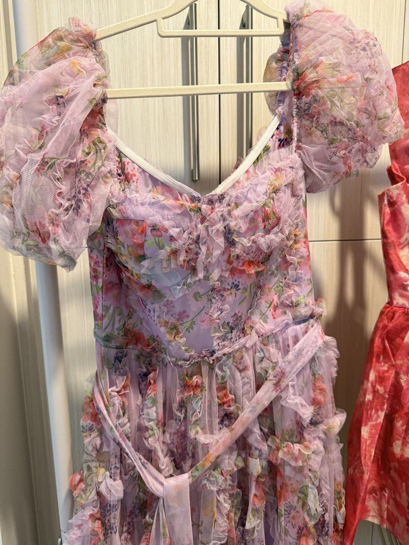 Pink Floral Gown (Category: Dresses) located in Cebu City. Submitted by onlineclosetbypat (Listing ID 1468284706, Image 1). Description: - Brand: Bangkok - Style: Floral tulle dress with all-over ruffles - Color: Soft pink and purple tones with vibrant flower print - Details: Sweetheart neckline, puff sleeves, and back zipper closure - Included: Matching tie belt at the waist - Size: Small (S) - Condition: Excellent / Never Used - Perfect for: We
