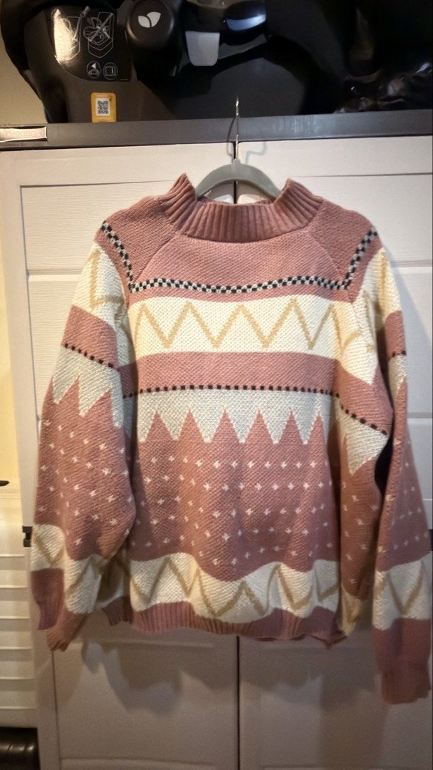 Pink patterned knit sweater with geometric design (Category: Coats, Jackets and Outerwear) located in Manila. Submitted by adoptmypreloveditems (Listing ID 1468477776, Image 2). Description: - Style: Cozy knit sweater with geometric pattern in dusty pink, cream, beige, and black - Fit: Relaxed fit with drop shoulders for ultimate comfort - Details: Chic mock neck collar, ribbed cuffs, and ribbed hem - Feel: Soft texture throughout, perfect for co