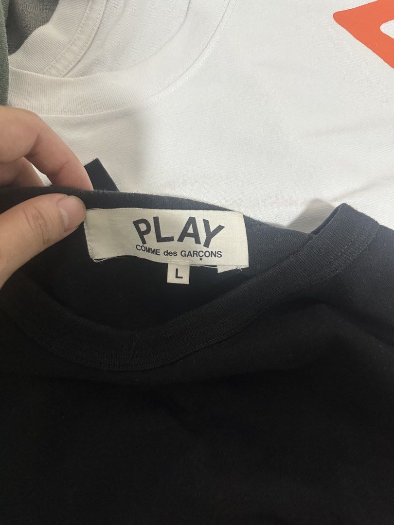 Play CDG Comme des Garcons Shirt (Category: Shirts) located in Subic. Submitted by declutterbyshit (Listing ID 1468378491, Image 2). Description: Play Comme des Garcons black tee, size large. Classic little heart logo embroidered on the chest. Crew neck collar, short sleeves. Simple staple piece for everyday outfits. Easy to style with denim or joggers. Standard fit..