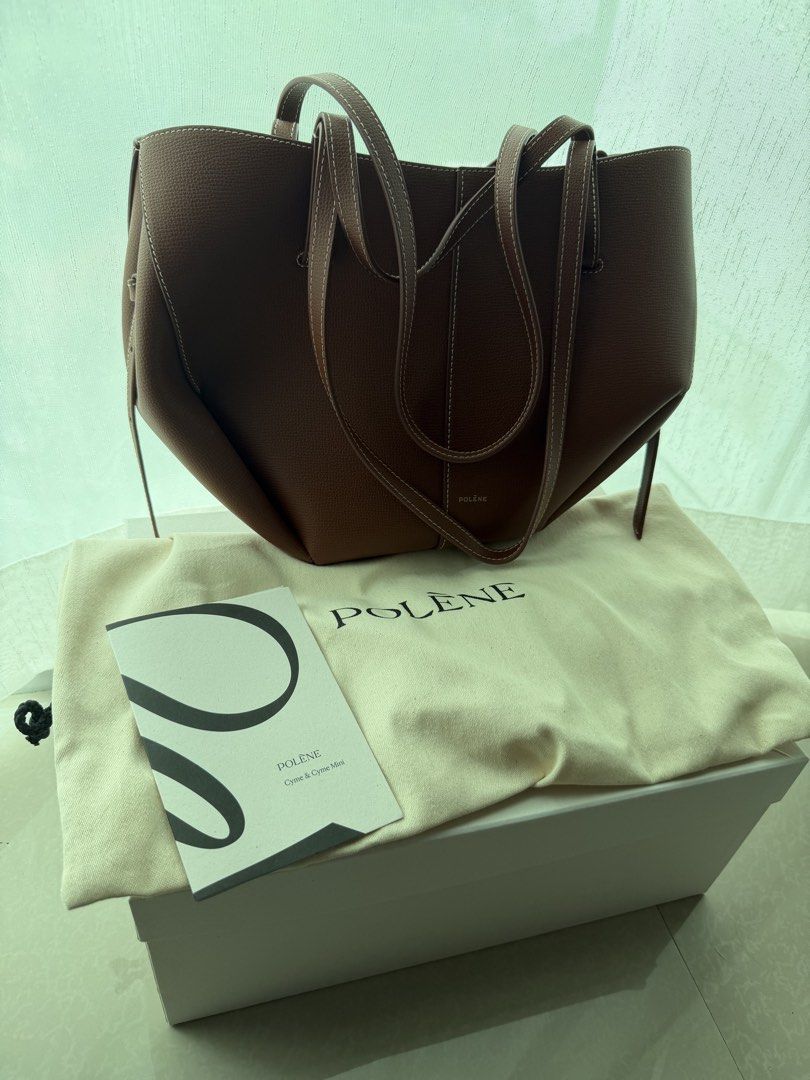 Polène Cyme Mini cognac (Category: Luxury Bags & Wallets) located in Cainta. Submitted by lovedbyiris975 (Listing ID 1468303053, Image 1). Description: - buttons still have protective layer of plastic - Complete with original dust bag, booklet, and white storage box.