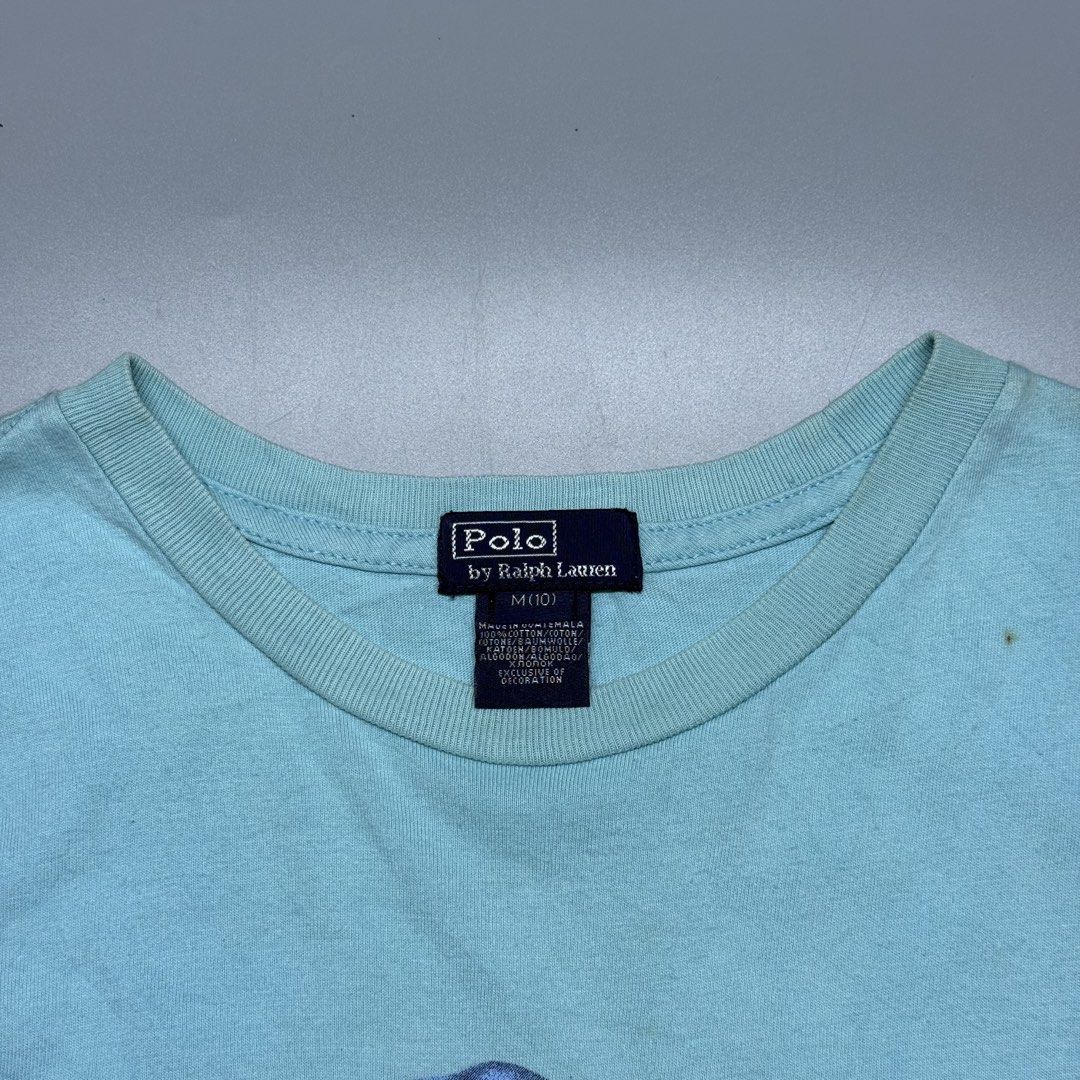 Polo by Ralph Lauren Bear (Category: Tshirts & Polo Shirts ) located in Kabacan. Submitted by rags2penny.phl (Listing ID 1468333222, Image 3). Description: - Brand: Polo by Ralph Lauren - Color: Light Blue - Design: Iconic bear graphic wearing a bucket hat and floral shorts - Details: Short sleeves, crew neck - Size: M(10) - Material: 100% Cotton - Origin: Made in Guatemala - Condition: Excellent pre-loved condition (ready to wear) Measurements :