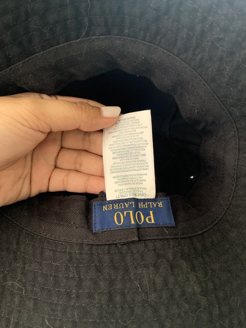 Polo Ralph Lauren Black Bucket Hat (Category: Caps & Hats) located in Mandaluyong City. Submitted by cjdp17 (Listing ID 1468317757, Image 2). Description: - Brand: Polo Ralph Lauren - Color: Black with embroidered white pony logo - Material: 100% cotton - Size: One size (59cm) - Condition: Good, with interior tag intact; needs a quick lint roll or clean due to surface dust - Perfect casual accessory for sunny days.