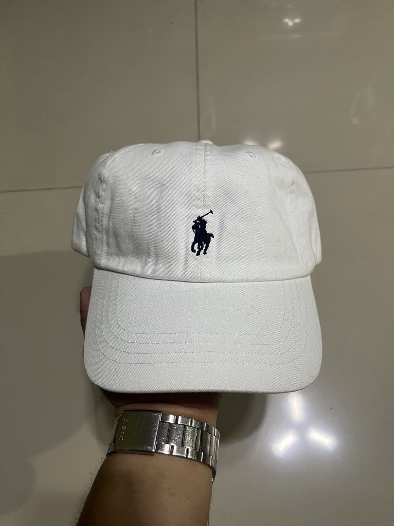 Polo Ralph Lauren White Baseball Cap (Category: Caps & Hats) located in Quezon City. Submitted by flip_da_cash (Listing ID 1468450221, Image 1). Description: - Brand: Polo Ralph Lauren - Color: Clean White with Dark Navy Pony Embroidery - Material: 100% Breathable Cotton - Details: 'POLO' embroidered on the back strap - Closure: Adjustable metal slider for a custom fit - Condition: Brand new / Excellent - Perfect daily staple for casual fits and 
