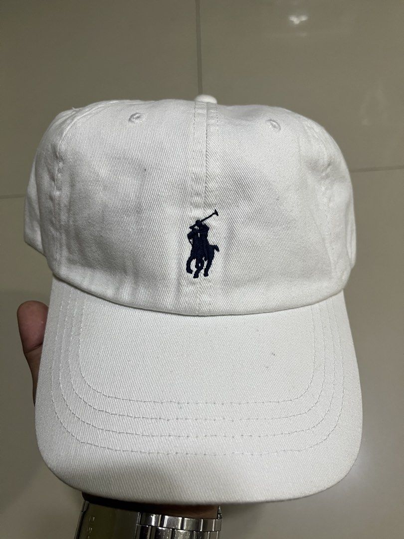 Polo Ralph Lauren White Baseball Cap (Category: Caps & Hats) located in Quezon City. Submitted by flip_da_cash (Listing ID 1468450221, Image 2). Description: - Brand: Polo Ralph Lauren - Color: Clean White with Dark Navy Pony Embroidery - Material: 100% Breathable Cotton - Details: 'POLO' embroidered on the back strap - Closure: Adjustable metal slider for a custom fit - Condition: Brand new / Excellent - Perfect daily staple for casual fits and 