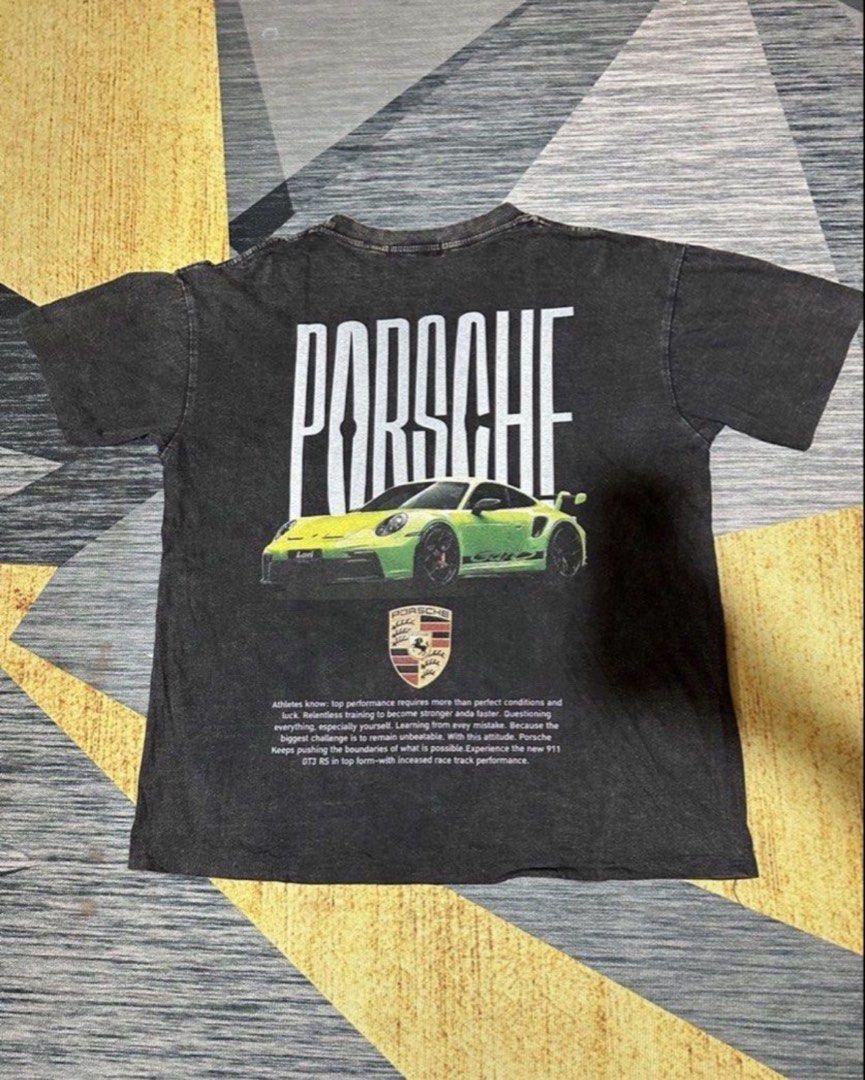 Porsche GT3RS shirt (Category: Tshirts & Polo Shirts ) located in Subic. Submitted by declutterbyshit (Listing ID 1468339634, Image 1). Description: - Color: Dark grey with acid wash finish (26x21.5) - Design: Large bright green Porsche 911 GT3 RS graphic with crest and text details - Fit: Standard boxy fit with short sleeves and crew neck - Condition: Clean collar and hem - Style: Casual streetwear, perfect for car enthusiasts.