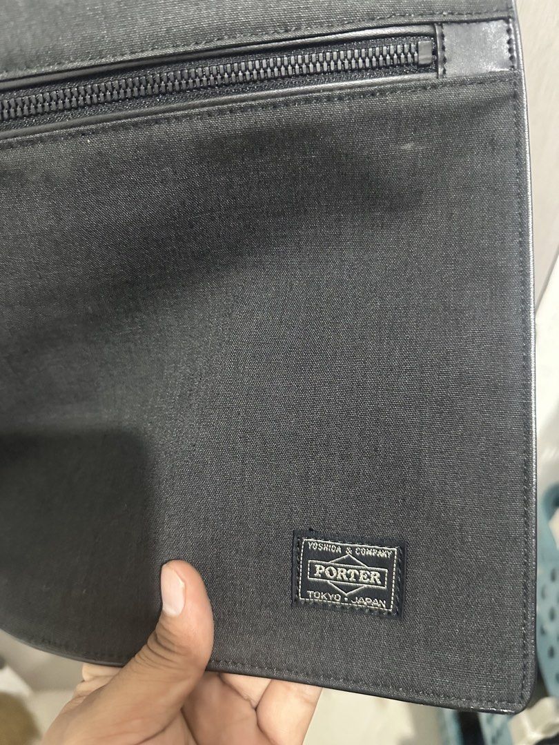 Porter Yoshida & Co Black Messenger Bag (Category: Sling Bags) located in Digos. Submitted by reywearfinds (Listing ID 1468409266, Image 3). Description: - Brand/Origin: Authentic Porter by Yoshida & Co. (Made in Tokyo, Japan) - Color: Classic Black - Dimensions: Approx. 14" W x 11" H - Material: Highly durable canvas-like fabric - Exterior: Front flap design with zippered pocket and iconic woven logo patch - Interior: Secure zipper closure under
