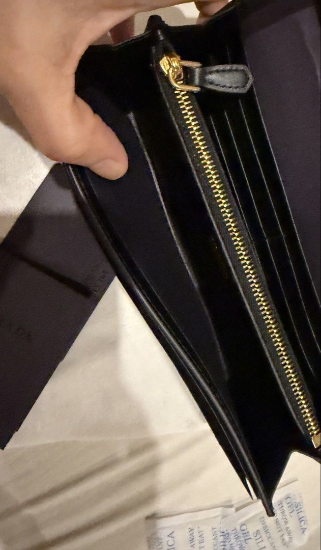 Prada Black Leather Long Wallet With Box (Category: Luxury Bags & Wallets) located in Pasig City. Submitted by fz718 (Listing ID 1468422018, Image 3). Description: - Authentic Prada wallet in classic black quilted leather - Luxurious gold-tone hardware and iconic front triangle logo plaque - Secure snap button closure - Interior features multiple card slots, slip compartments, and a zippered coin pocket - Crafted in Italy - Comes with original br