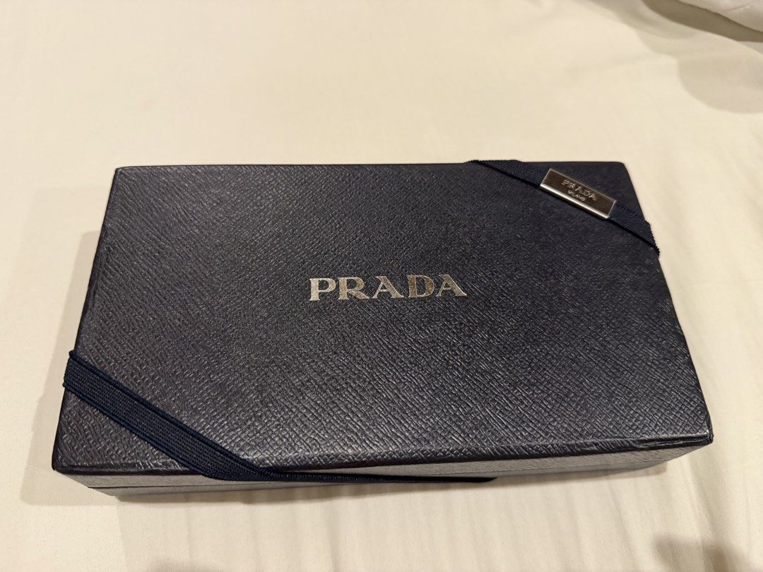 Prada Black Leather Long Wallet With Box (Category: Luxury Bags & Wallets) located in Pasig City. Submitted by fz718 (Listing ID 1468422018, Image 1). Description: - Authentic Prada wallet in classic black quilted leather - Luxurious gold-tone hardware and iconic front triangle logo plaque - Secure snap button closure - Interior features multiple card slots, slip compartments, and a zippered coin pocket - Crafted in Italy - Comes with original br