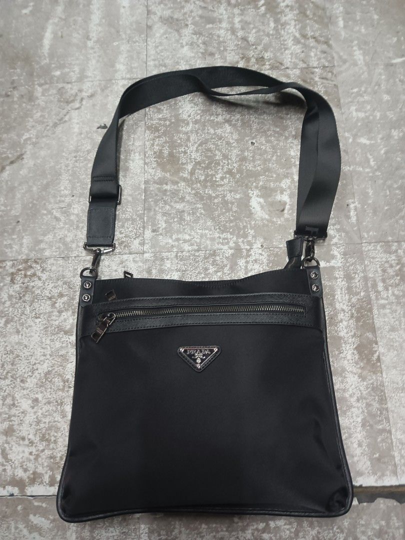 Prada Milano Black Nylon Crossbody Bag (Category: Sling Bags) located in Baguio. Submitted by brandeditems16 (Listing ID 1468478990, Image 1). Description: - Authentic Prada Milano black nylon crossbody bag - Sleek silver-tone hardware with iconic metal triangular logo plaque - Convenient front zip pocket and top zipper closure - Adjustable black canvas strap with secure metal clips - Branded fabric interior lining with metal logo plate - Compact