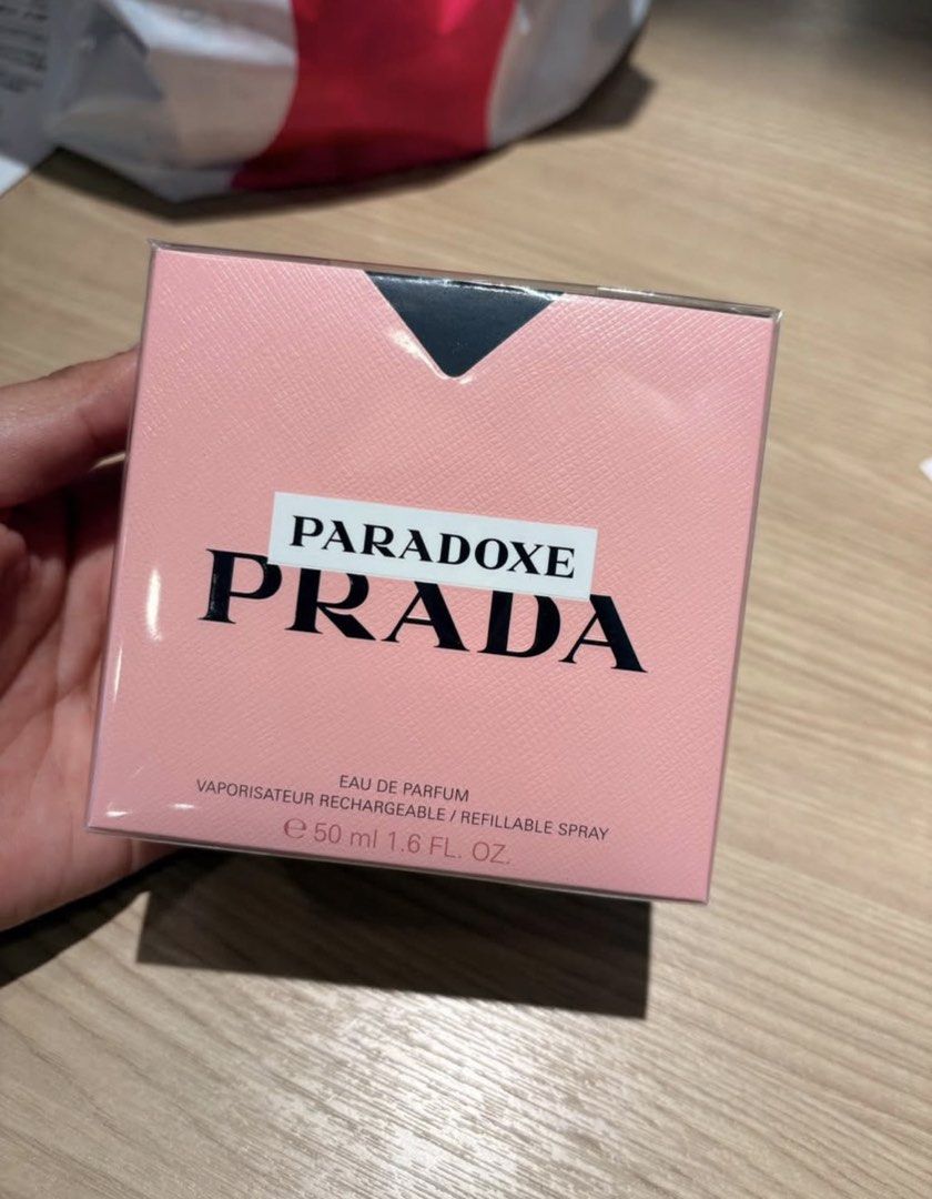 Prada Paradoxe Eau De Parfum 50ml (Category: Fragrance & Deodorants) located in Manila. Submitted by jergomez (Listing ID 1468413977, Image 1). Description: - Brand: Prada Paradoxe - Type: Eau de Parfum (EDP) - Size: 50ml / 1.6 fl. oz. - Condition: Brand new, unopened with plastic wrap still sealed - Packaging: Pink outer box with black lettering and Saffiano leather pattern - Feature: Refillable spray bottle format - 100% Authentic and ready to 