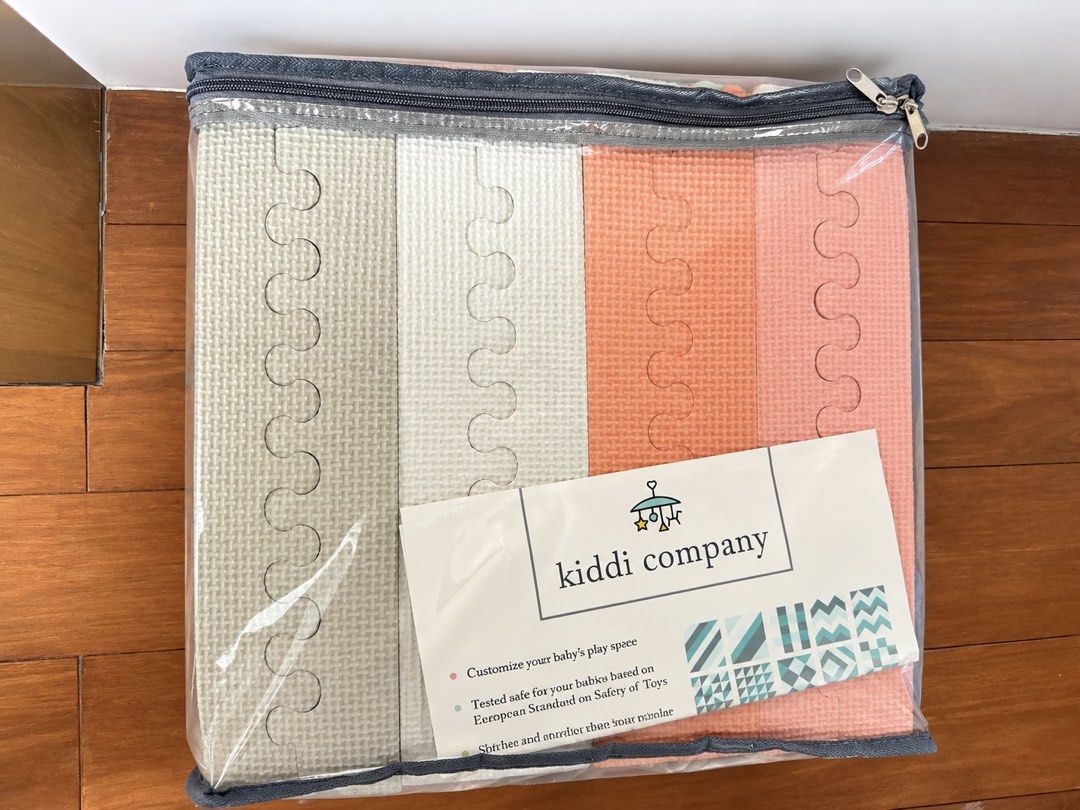 PRELOVED Kiddi Company Interlocking Foam Play Mat Set (Category: Infant Playtime) located in Quezon City. Submitted by myshoppe_qc (Listing ID 1468292734, Image 2). Description: - Brand: Kiddi Company - Set includes: 40 triangle pieces and 32 edge pieces - Assembled size: 70 x 56 inches (10 mm thickness) - Features customizable geometric patterns - Material: Safe, non-toxic foam - Certified: Meets European toy safety standards - Packaging: Comes 