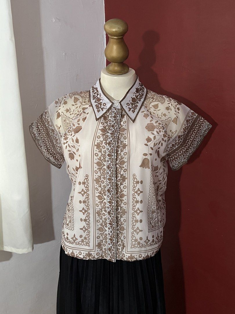 Premium BKK top (Category: Blouses) located in Cagayan de Oro. Submitted by takinasphere (Listing ID 1468386871, Image 1). Description: - 2XL on tag but fits L-XL best - Cream short sleeve button-up shirt - Brown floral and paisley print design - Collared neckline with matching patterned trim - Lightweight and slightly sheer fabric - Classic retro style, easy to pair with skirts or high-waisted trousers.