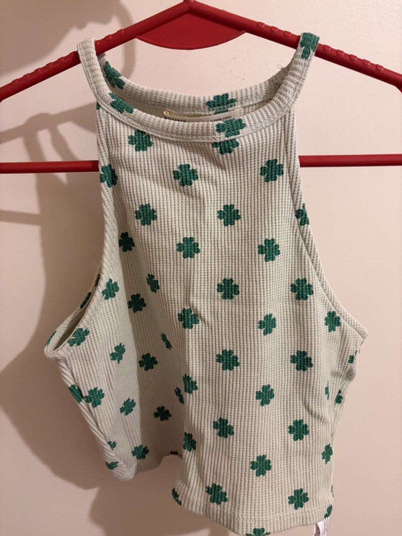 Pull&Bear halter top (Category: Sleeveless) located in Mandaluyong City. Submitted by icheeellee (Listing ID 1468436864, Image 1). Description: - Brand: Pull&Bear - Style: High halter neck crop top - Color/Pattern: Light green with dark green clover print - Fabric: Textured waffle knit - Size: Extra Small (XS).