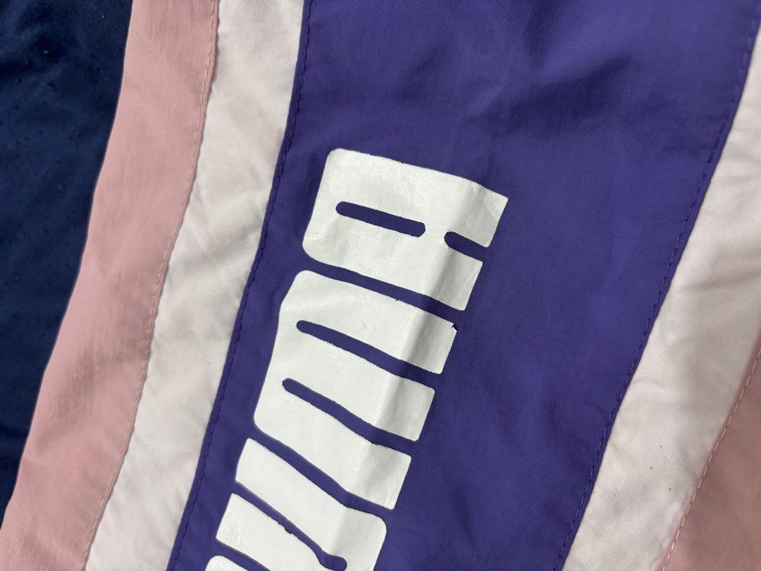 Puma Colorblock Windbreaker Jacket (Category: Coats, Jackets and Outerwear) located in Dasmarinas. Submitted by thriftedgirlie (Listing ID 1468322306, Image 2). Description: - Brand: Puma - Style: Colorblock windbreaker (White, Pink, Purple) - Size: XXL - Features: Half-zip front, hooded neckline, elastic cuffs and hem - Design: Bold vertical PUMA sleeve logos, horizontal chest flap pocket print, and back branding - Condition: Excellent pre-loved