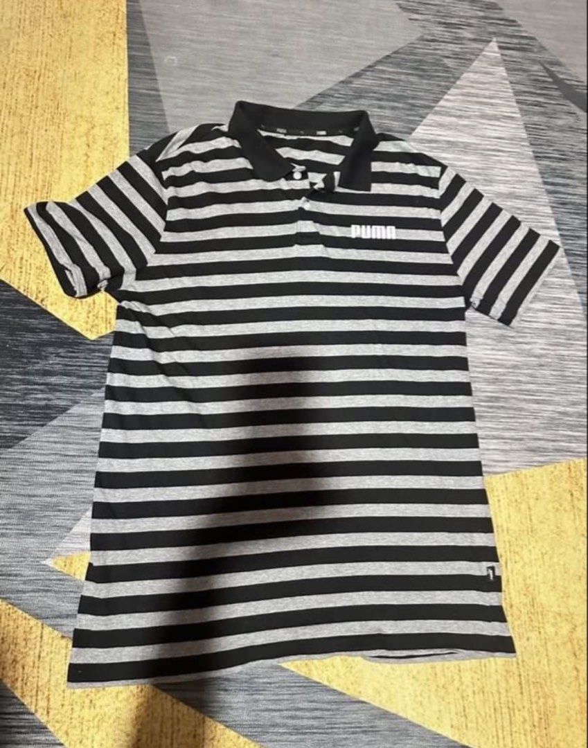 Puma Polo Shirt (Category: Tshirts & Polo Shirts ) located in Subic. Submitted by declutterbyshit (Listing ID 1468331146, Image 1). Description: Puma polo shirt Used once or Washed once lang ata pero new 29x20 350 - Design: Black and grey stripes with white Puma logo on chest - Details: Classic collar with two white buttons, ribbed black collar and cuffs - Fit/Material: Comfortable casual wear - Ideal for: Everyday outings or sports activities.