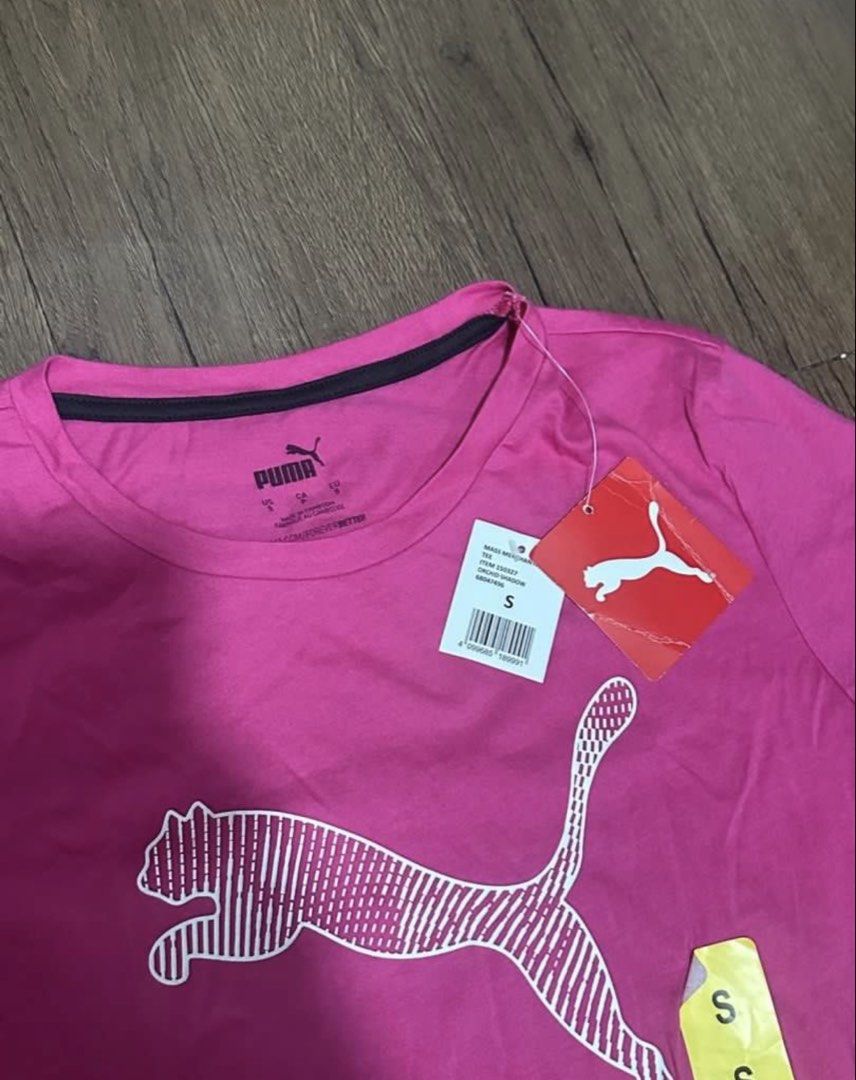 Puma Running Tee Dri - Fit shirt (Category: Shirts) located in Subic. Submitted by declutterbyshit (Listing ID 1468307285, Image 2). Description: - Brand: Puma Length 25 width 16 - Color: Bright pink with a large white striped cat logo - Size: Small - Condition: Brand new with original tags attached, unworn - Fit/Style: Casual fit, short sleeves, round neckline.