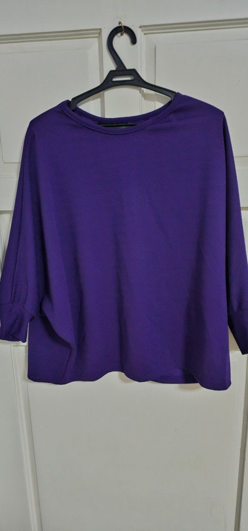 Purple long sleeve blouse (Category: Longsleeves) located in Davao. Submitted by sachigo (Listing ID 1468384196, Image 1). Description: - Color: Vibrant purple - Style: Loose fit with round neckline - Sleeves: Long sleeves with trendy cinched cuffs - Fabric: Lightweight and textured for all-day comfort - Versatility: Easy to style with both jeans and skirts - Condition: Brand new / Excellent.