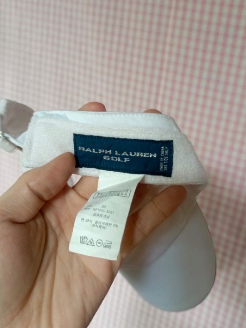 Ralph Lauren Golf White Visor Hat (Category: Caps & Hats) located in Digos. Submitted by jenepiisid83759 (Listing ID 1468351254, Image 3). Description: - Authentic Ralph Lauren golf visor in classic white - Features iconic embroidered logo on the front - Adjustable metal buckle strap with embossed branding for a custom fit - Comfortable interior terry cloth sweatband to keep you dry - Complete with inner care tags and product codes - One size fit