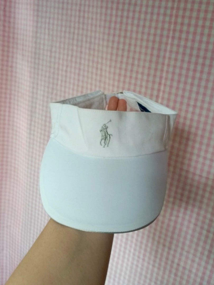 Ralph Lauren Golf White Visor Hat (Category: Caps & Hats) located in Digos. Submitted by jenepiisid83759 (Listing ID 1468351254, Image 1). Description: - Authentic Ralph Lauren golf visor in classic white - Features iconic embroidered logo on the front - Adjustable metal buckle strap with embossed branding for a custom fit - Comfortable interior terry cloth sweatband to keep you dry - Complete with inner care tags and product codes - One size fit