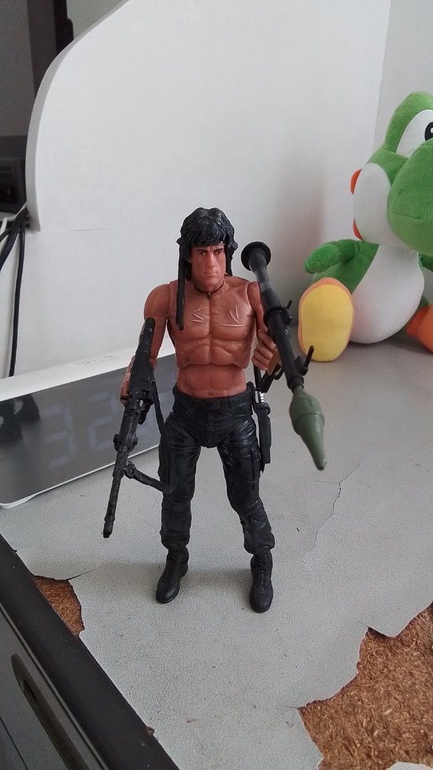 Rambo Action Figure with Weapons (Category: Action & Battle Toys) located in Paranaque City. Submitted by juntee.pabo (Listing ID 1468343606, Image 1). Description: - John Rambo action figure with iconic bare-chested muscular physique - Features detailed painted scars, long dark hair, and black tactical pants - Armed and ready with a rocket launcher in one hand and a machine gun in the other - Perfect collectible piece for fans and collectors of 
